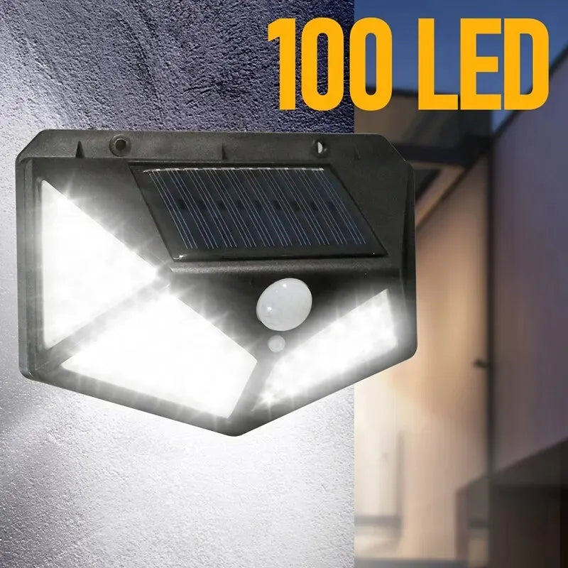 100 LED Solar Wall Lamp with motion sensor, illuminating bright white light in outdoor setting.