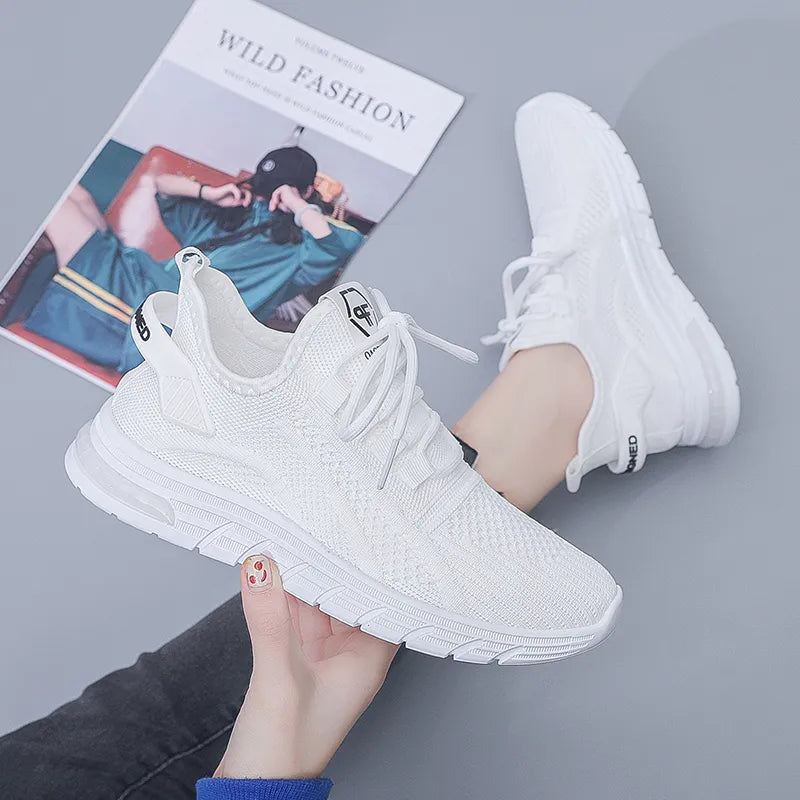 Women breathable white mesh sneakers with lace-up closure.