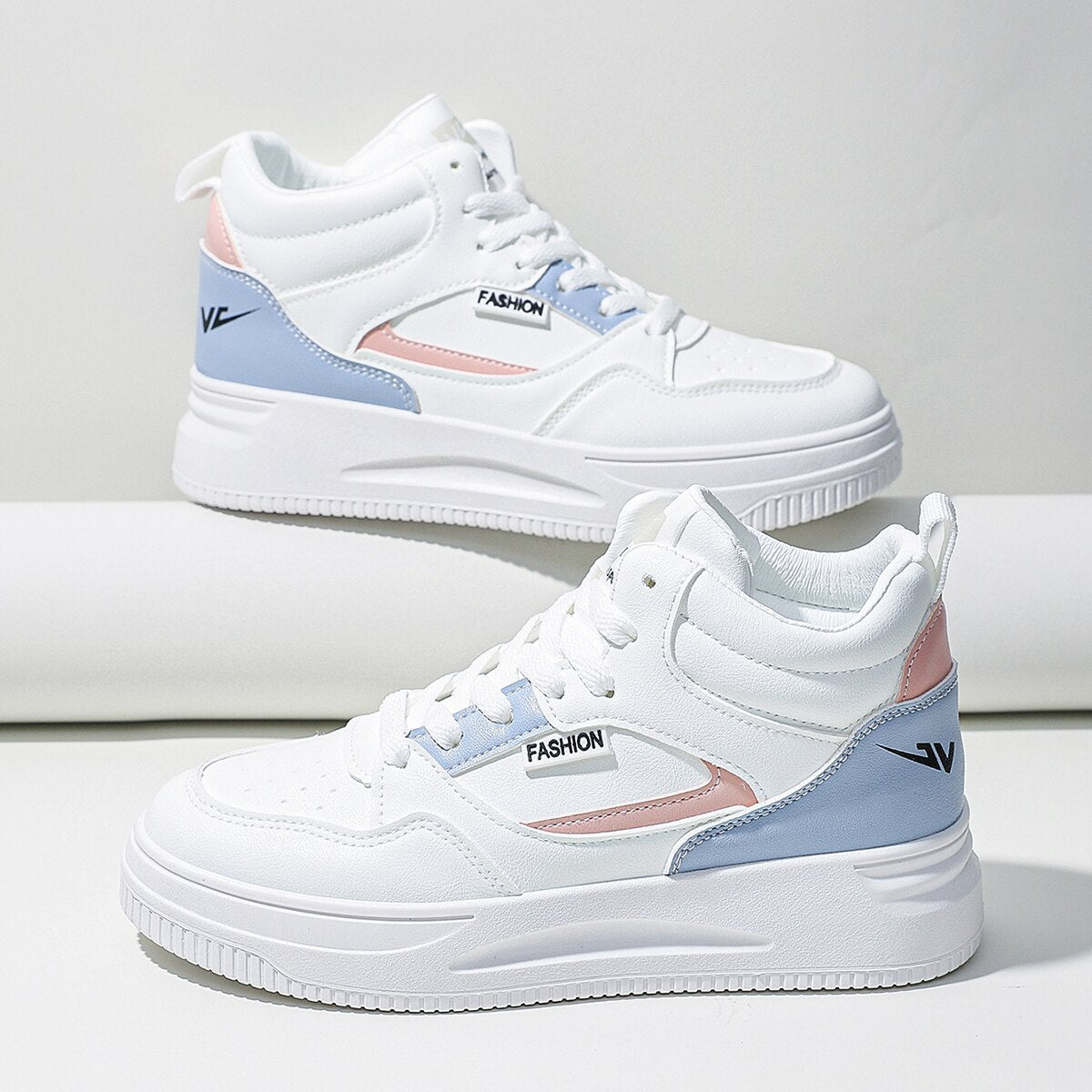 Women’s white colorblock high top platform sneakers with lace-up design for casual wear.