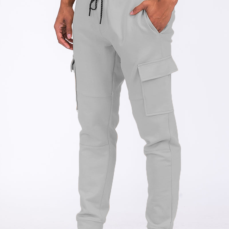 Men's cotton cargo trousers with pockets and cuffed legs, casual jogger style.