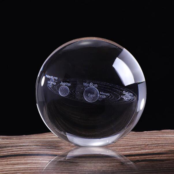 3D Solar System crystal ball with engraved planets on a glass base, perfect for home decoration.