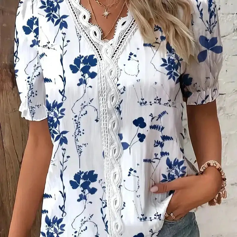 V-neck white blouse with blue 3D floral print and lace decoration, casual summer fashion for women.